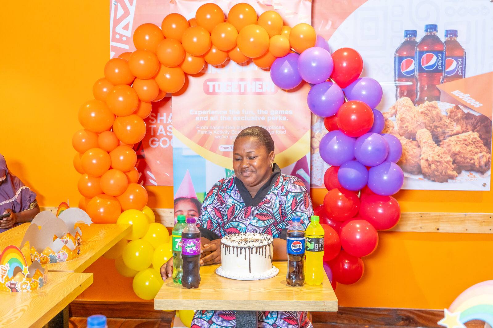 Birthday cake and balloons at a Kookoos party